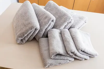 a pile of towels sitting on top of a table at Ayame Building in Tokyo