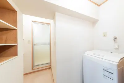 a laundry room with a washer and dryer and a window at Ayame Building in Tokyo