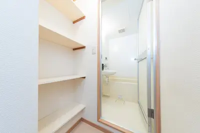 a bathroom with a walk in shower next to a mirror at Ayame Building in Tokyo