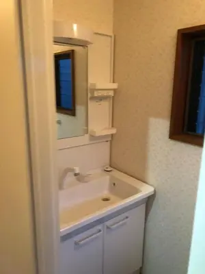 a bathroom with a sink and a mirror at OZ sumida in Tokyo