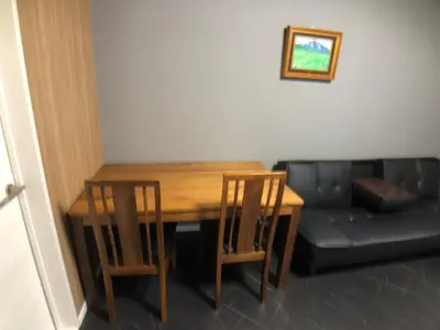 a dining room table with two chairs and a couch at OZ sumida in Tokyo