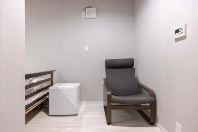 a chair sitting in a corner of a room at OZ sumida in Tokyo