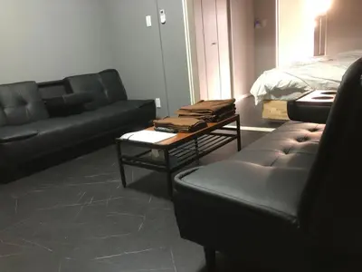 a living room with two couches and a bed at OZ sumida in Tokyo