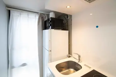 a small kitchen with a sink and a refrigerator at Urban Nest Otsuka 301 JR OTSUKA STATION in Tokyo