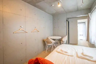 a bedroom with a bed and a table and chairs at Pure Rest Otsuka 302 JR Otsuka Station in Tokyo