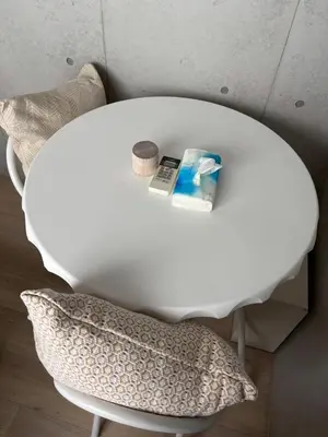 a white table with a pillow next to a chair at Pure Rest Otsuka 302 JR Otsuka Station in Tokyo