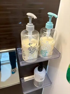 two bottles of detergent on shelves in a bathroom at Pure Rest Otsuka 302 JR Otsuka Station in Tokyo