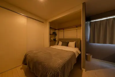 a bedroom with a bed in a room with a window at HOTEL AndPlace Sasaduka in Tokyo