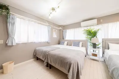 a bedroom with two beds and a window at HOTEL AndPlace Sasaduka in Tokyo