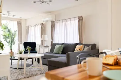 a living room with a couch and a table at HOTEL AndPlace Sasaduka in Tokyo