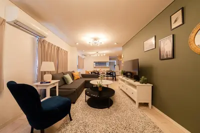 a living room with a couch and a table at HOTEL AndPlace Sasaduka in Tokyo