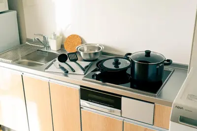a kitchen stove with two pots and pans on it at Asakusa Sky Tokyo Condominium hotel in Tokyo