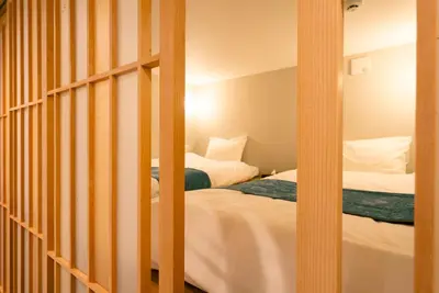two beds in a room with two beds sidx sidx sidx at Asakusa Sky Tokyo Condominium hotel in Tokyo