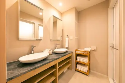 a bathroom with two sinks and a large mirror at Asakusa Sky Tokyo Condominium hotel in Tokyo