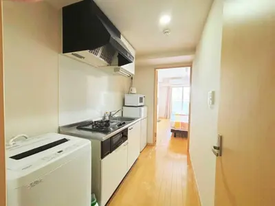 a small kitchen with a stove and a sink at \u30a2\u30eb\u30b9\u30db\u30fc\u30e0 \u6c60\u888b in Tokyo