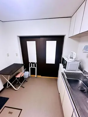 a small kitchen with a sink and a microwave at Tokyo Shinjuku East Goose Goose House in Tokyo