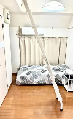 a bed frame in a room with a bed at Tokyo Shinjuku East Goose Goose House in Tokyo