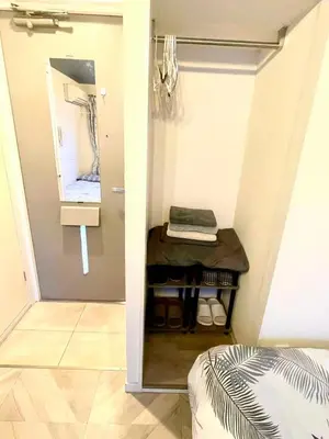 a room with a closet with a mirror and a table at Tokyo Shinjuku East Goose Goose House in Tokyo