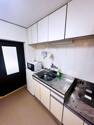 a small kitchen with a sink and a microwave at Tokyo Shinjuku East Goose Goose House in Tokyo