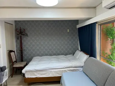 a small bedroom with a bed and a couch at \u6771\u65b0\u5bbf\u30a8\u30ea\u30a277 in Tokyo