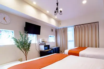 a hotel room with two beds and a tv at -Higashi-shinjuku 9F- Entire floor rental in Tokyo