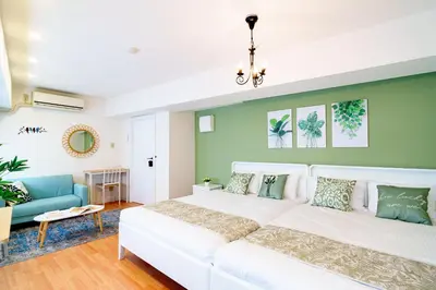 a bedroom with a white bed and a green wall at -Higashi-shinjuku 9F- Entire floor rental in Tokyo