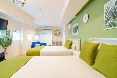 two beds in a room with green walls at -Higashi-shinjuku 9F- Entire floor rental in Tokyo