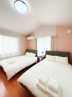 a bedroom with two beds with white sheets at Ueno&Asakusa Stay Whole House for 11, Great Access in Tokyo