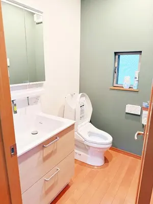 a bathroom with a toilet and a sink and a mirror at Ueno&Asakusa Stay Whole House for 11, Great Access in Tokyo