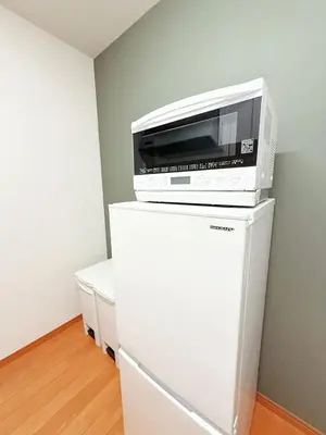a microwave sitting on top of a refrigerator at Ueno&Asakusa Stay Whole House for 11, Great Access in Tokyo