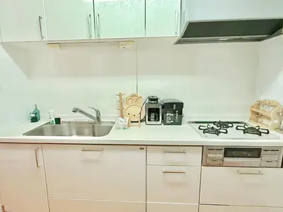 a white kitchen with a sink and a stove at Ueno&Asakusa Stay Whole House for 11, Great Access in Tokyo