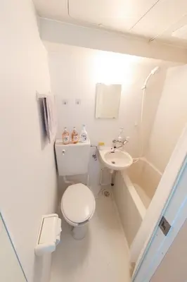 a small bathroom with a toilet and a sink at \u30cf\u30a4\u30af\u30ec\u30b9\u30c8\u4e2d\u91ce103 in Tokyo