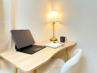 a laptop computer sitting on a desk with a lamp at Shinjuku Cozy Loft, 2BR, 3DoubleBeds&Living in Tokyo