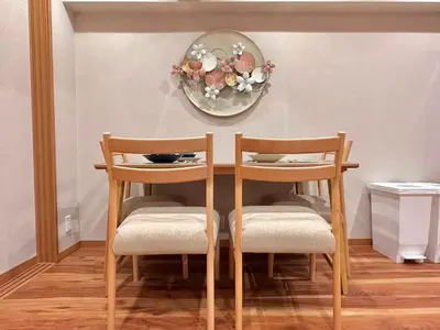 a dining room table with two chairs and a plate on the wall at A\u65b0\u5bbf\u6700\u4e2d\u5fc3 \u6b4c\u821e\u4f0e\u753a 3bedrooms 2bathrooms 2toiltes\u6b65\u884c\u5230\u4e1c\u65b0\u5bbf4\u5206\u949f \u6b65\u884c\u5230\u65b0\u5bbf9\u5206\u949f Max8 in Tokyo