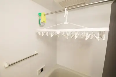 a white bathroom with a tub and a shower curtain at Guest House KAMEARI 203 in Tokyo