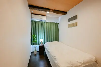 a small bedroom with a bed and a window at Seed INN Iori-\u5eb5- in Tokyo