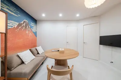 a living room with a table and a couch at Lucky you! SHIBUYA in Tokyo