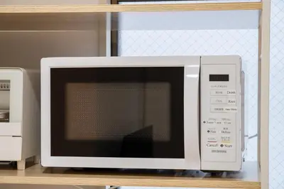 a microwave oven sitting on top of a shelf at Lucky you! SHIBUYA in Tokyo