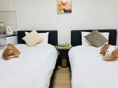 two beds with stuffed teddy bears sitting on them at Shinagawa City \u834f\u539f101-SN0479 in Tokyo