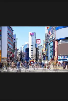a group of people crossing a street in a city at \u6a31\u82b1\u5bbf\u6d89\u8c37\u7ad9\u5f92\u6b654\u5206\u949f in Tokyo