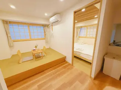 a room with a table and a bed and a mirror at Silvership Hotel 201 in Tokyo