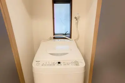 a washing machine in a room with a window at Silvership Hotel 201 in Tokyo