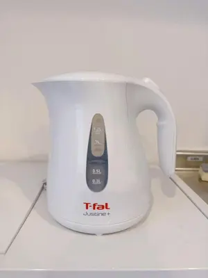 a tea kettle with a remote control in it at Silvership Hotel 201 in Tokyo