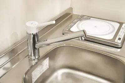 a bathroom sink with a faucet and a toilet at Silvership Hotel 301 in Tokyo