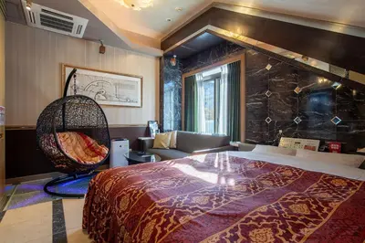 a bedroom with a large bed and a chair at Charme Hotel, Romantic Hideaway in Central Tokyo in Tokyo