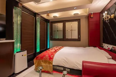 a bedroom with a bed with red and green accents at Charme Hotel, Romantic Hideaway in Central Tokyo in Tokyo