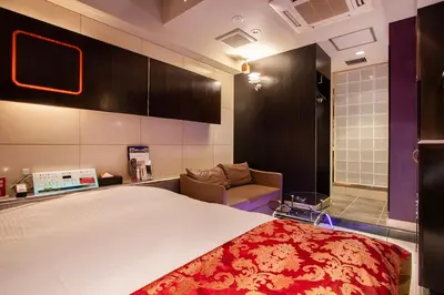 a bedroom with a bed and a couch in it at Charme Hotel, Romantic Hideaway in Central Tokyo in Tokyo