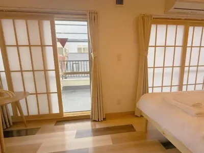 a bedroom with a bed and a large window at Silvership Hotel 502 in Tokyo