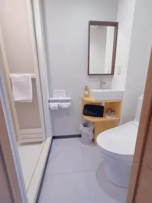 a white bathroom with a toilet and a sink at Silvership Hotel 502 in Tokyo