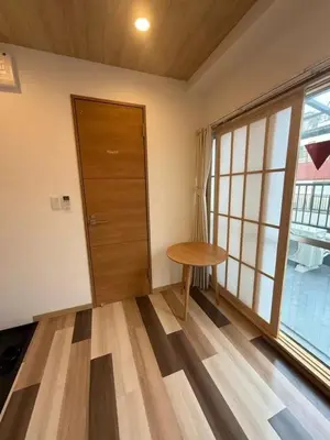 a room with a door and a table and a window at Silvership Hotel 502 in Tokyo